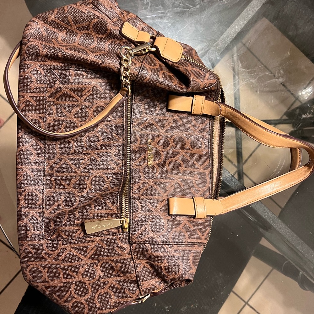 Calvin Klein hand or shoulder purse. Dark brown/light brown straps. Ck design